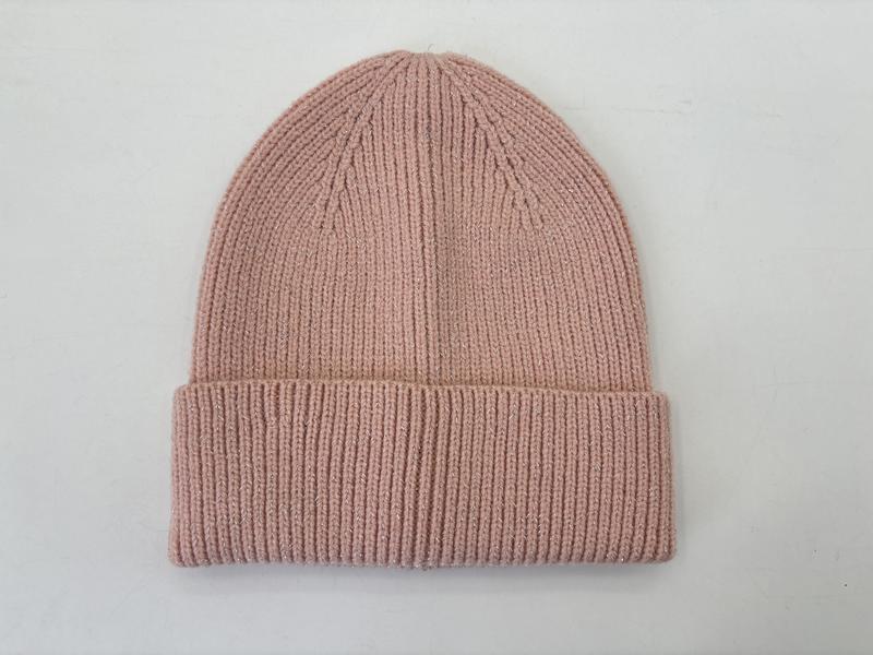 Blush pink ribbed knit cuffed beanie hat laid flat on white background, soft fine-knit winter cap