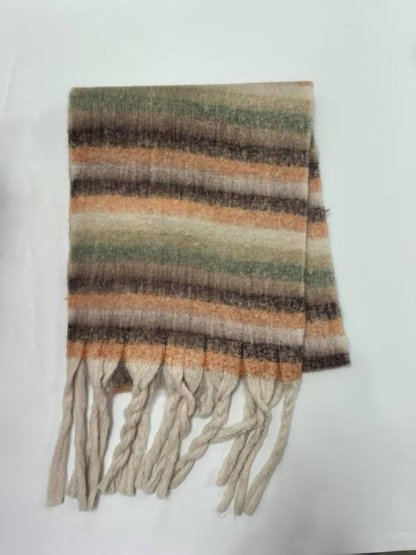 Folded striped scarf in earthy orange, green, beige, and brown tones with twisted cream fringe tassels on white background
