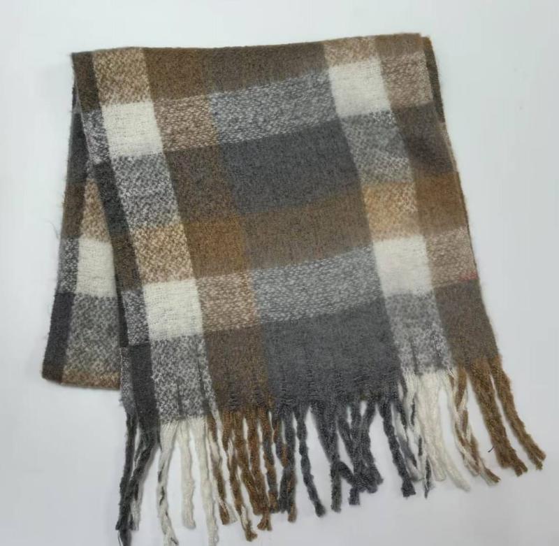 Folded plaid scarf in brown, grey, and cream with twisted fringe trim on white background