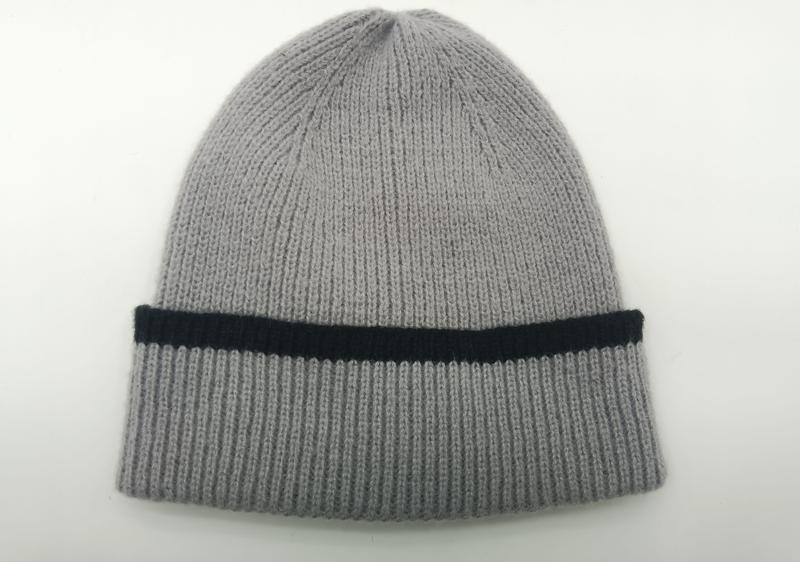 Light grey ribbed knit beanie hat with folded cuff featuring a single black contrast stripe, laid flat on white background
