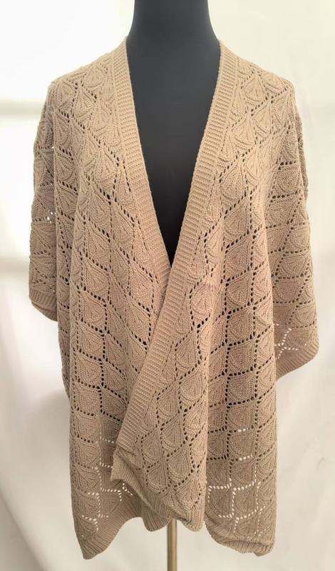 Beige oversized open-front knit cardigan with square leaf lace crochet pattern displayed on a mannequin