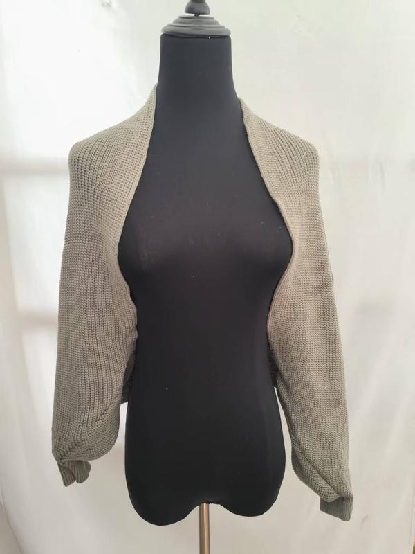 Taupe chunky knit cropped shrug cardigan with long sleeves displayed on a black dress form mannequin