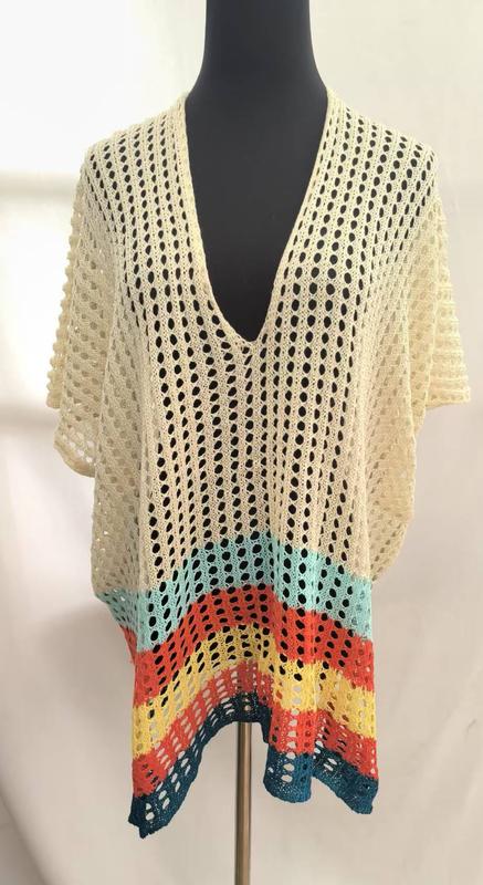 Cream crochet open-knit tunic top with deep V-neck and multicolor striped hem in teal, orange, yellow on mannequin