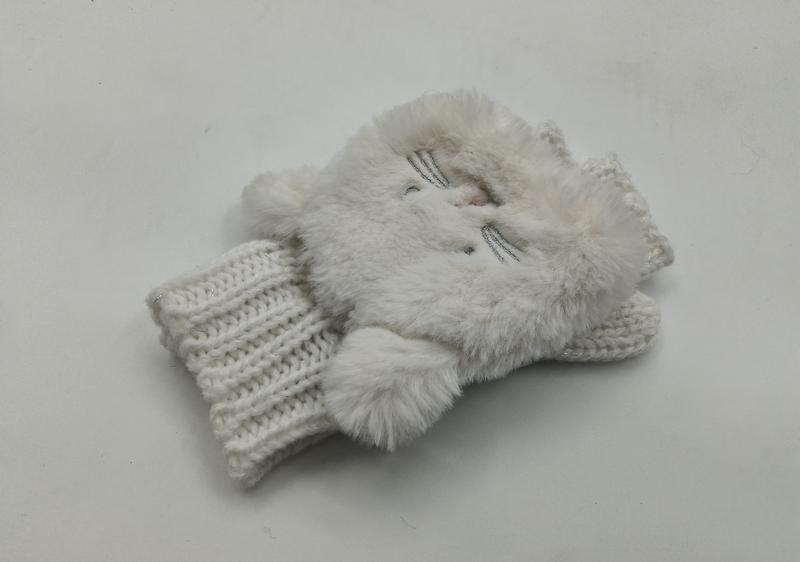 Pair of white faux fur fingerless gloves with cat face design and chunky knit ribbed cuff on white background