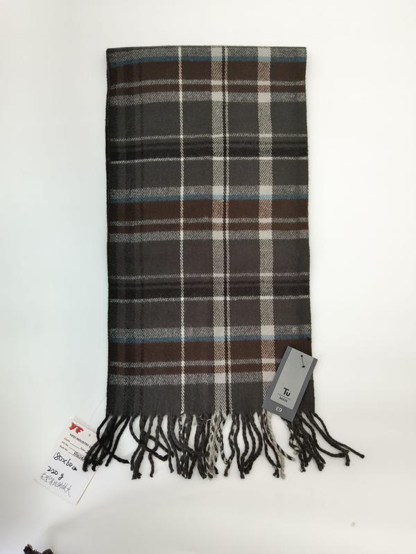 Men's grey and brown tartan plaid scarf with white and blue accents and knotted fringe ends laid flat on white background