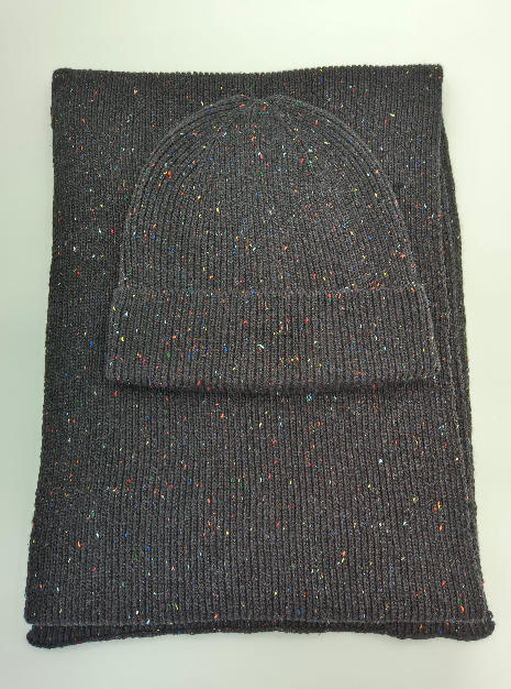 Dark grey knitted beanie hat and matching scarf set with multicolor confetti speckle pattern, laid flat on white background