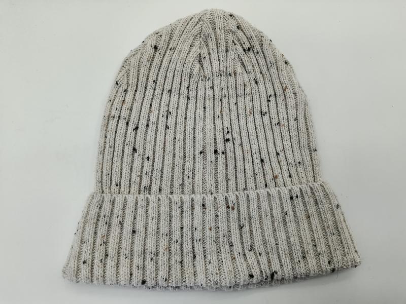 Light grey ribbed knit beanie hat with multicolor fleck tweed pattern and folded cuff, laid flat on white background