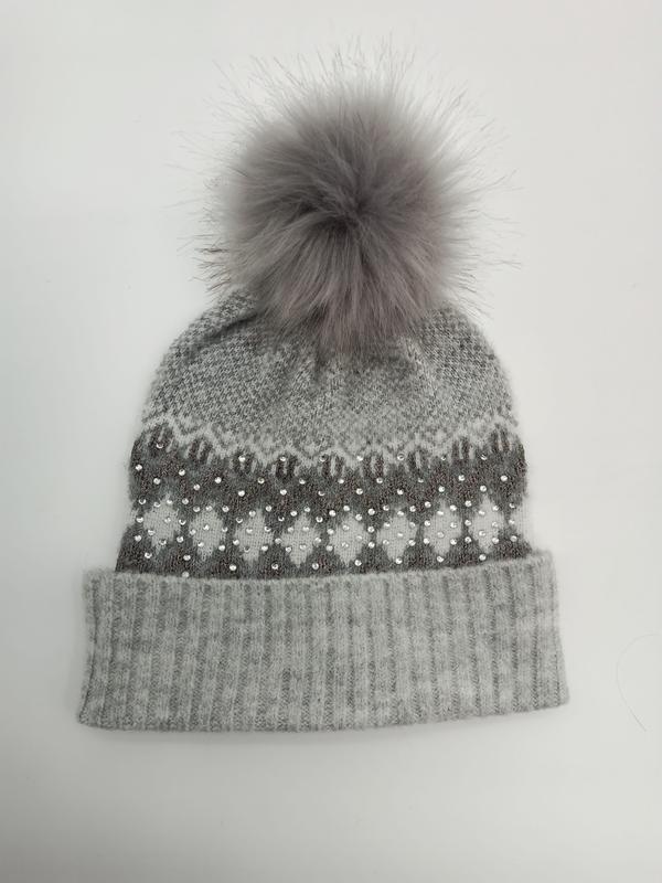 Gray knit winter beanie with Fair Isle snowflake pattern, crystal rhinestone details, ribbed cuff, and fluffy faux fur pom-pom on top