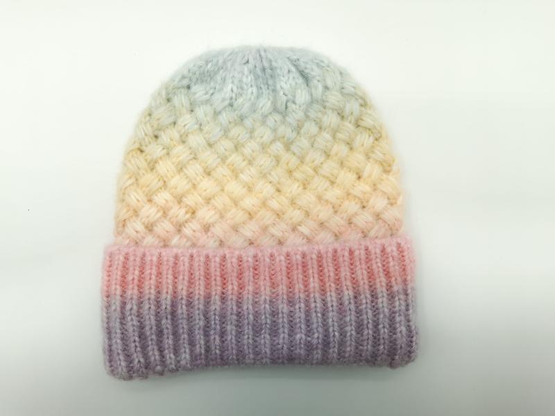 Handknit beanie hat with pastel rainbow gradient from lavender to blue, featuring basket weave texture and ribbed cuff
