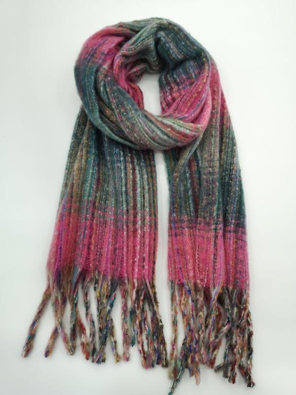 Soft woven plaid scarf in pink and teal with multicolor fringe ends, looped and laid flat on white background