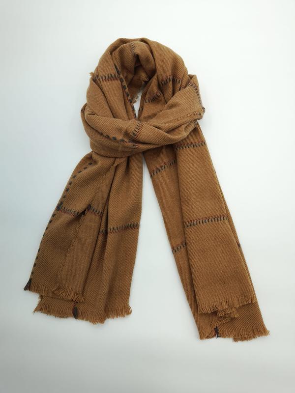 Camel brown wool scarf with dark zigzag stripe pattern, loosely knotted and displayed flat on white background with fringe edges