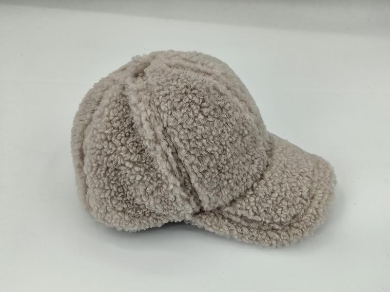 Beige sherpa fleece baseball cap with structured brim and panel seams, photographed on white background
