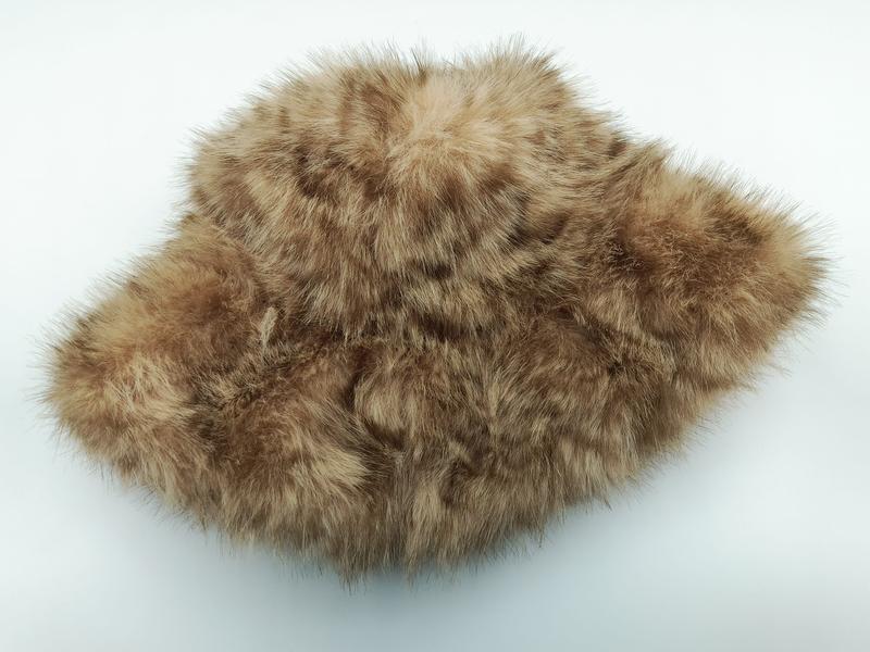 Tan and brown spotted faux fur fluffy pillow cover with soft textured pile on white background