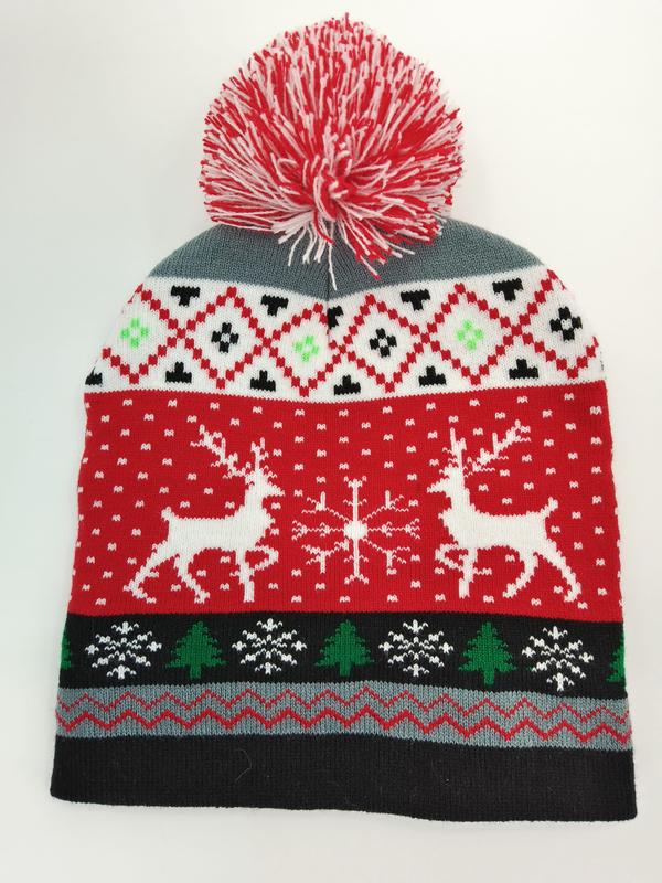 Red and white Fair Isle knit Christmas beanie hat with reindeer, snowflakes, trees, and red-white pom pom on top