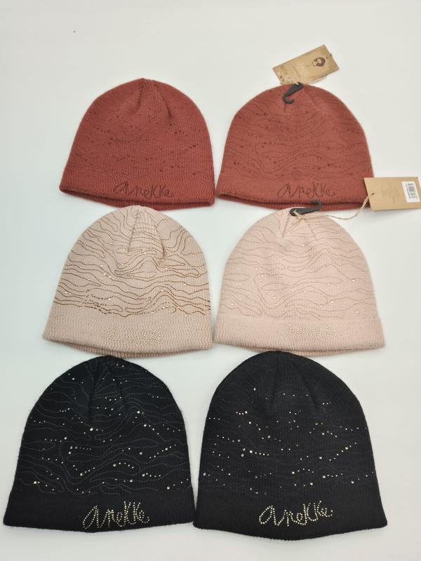 Six knit beanies in terracotta, blush pink, and black with rhinestone accents and wavy embroidered pattern, arranged in pairs