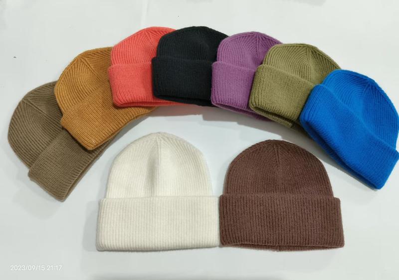 Collection of 10 ribbed knit cuffed beanie hats in assorted colors including white, black, red, blue, purple, olive, brown, and camel on white background