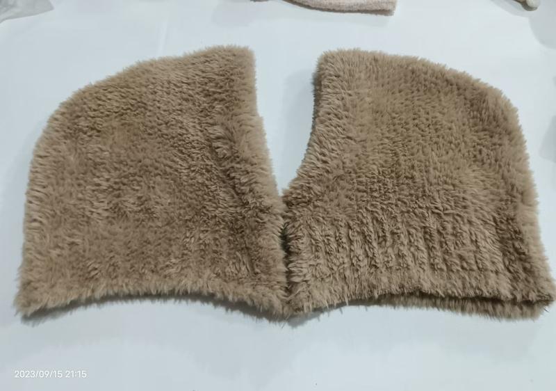 Flat lay of a beige faux fur shaggy collar wrap with V-neckline opening, placed on white surface