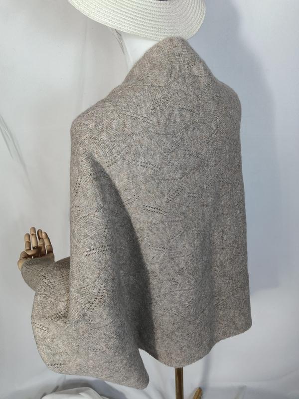 Light gray lace knit wool wrap shawl draped on mannequin, showing diamond openwork pattern and soft textured fabric