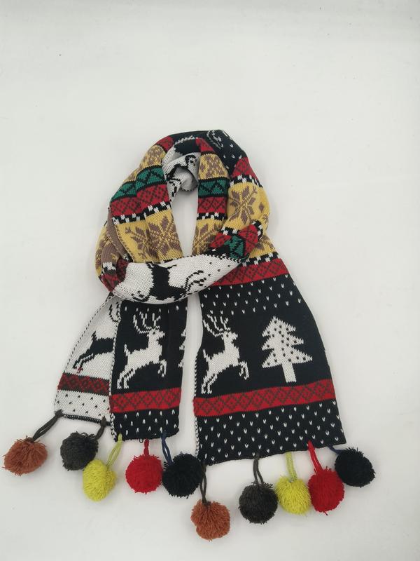 Colorful knit winter scarf with reindeer, Christmas tree Fair Isle pattern and multicolor pom-pom fringe ends