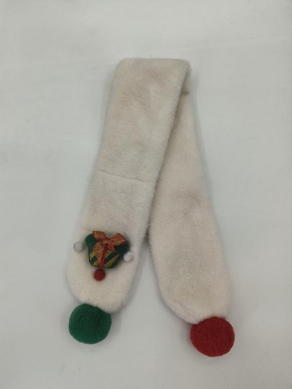 Cream faux fur scarf with green and red pom pom ends and embroidered Christmas bell brooch on white background
