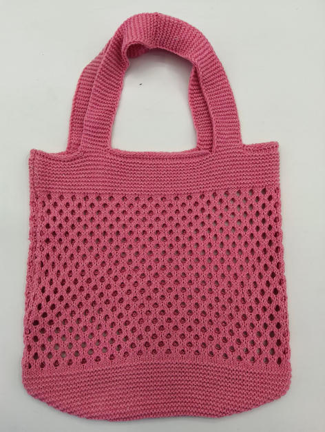Pink knitted cotton mesh tote bag with open crochet pattern and dual top handles on white background