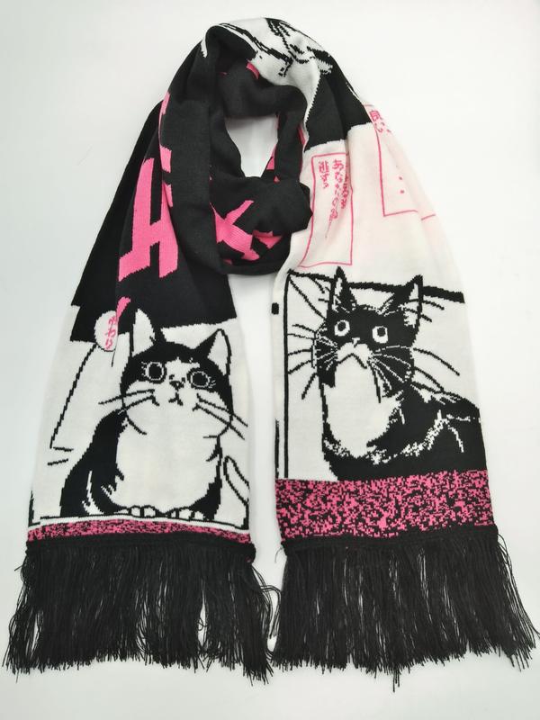 Knit scarf with black and white manga-style cat illustrations, pink Japanese text accents, and black fringe trim