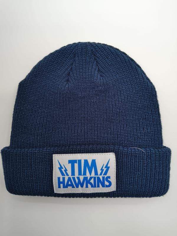 Navy blue ribbed knit cuffed beanie hat with white and blue Tim Hawkins lightning bolt logo patch on folded cuff