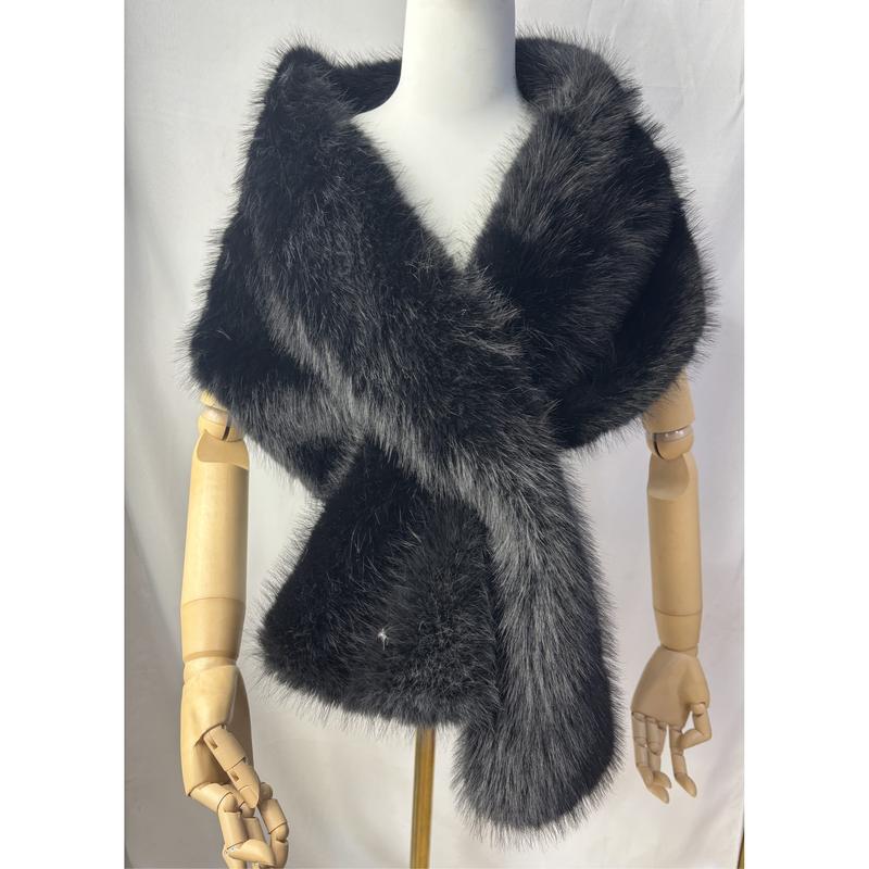 Black faux fur wrap shawl displayed on mannequin, featuring fluffy texture, silver-tipped fur and rhinestone accent
