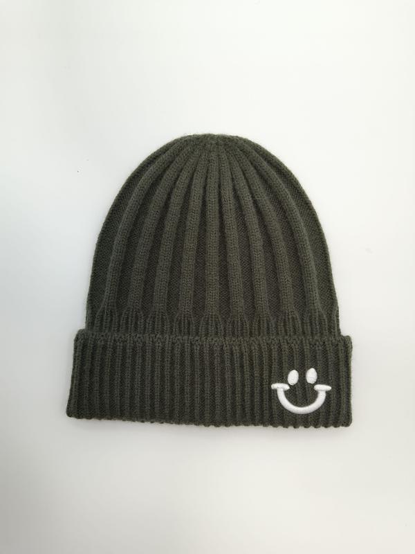 Olive green ribbed knit cuffed beanie hat with white embroidered smiley face on folded brim, laid flat on white background