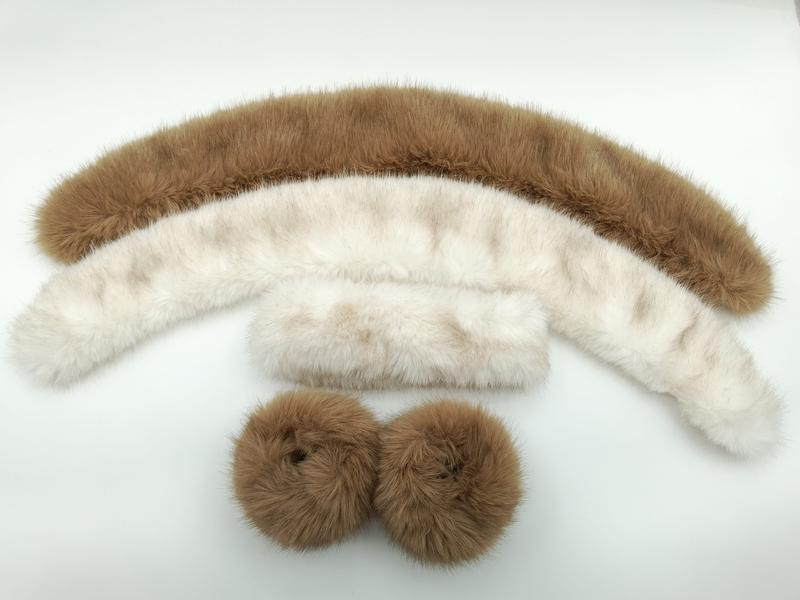 Three-piece faux fur trim set including large camel arc collar, ivory scarf collar, and pair of camel fur cuffs on white background