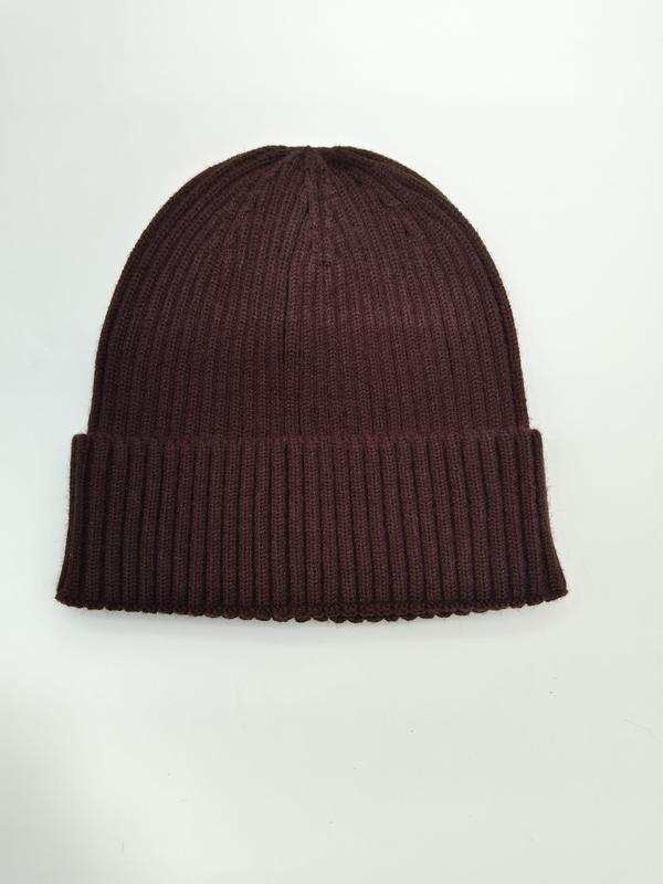 Deep burgundy ribbed knit beanie hat with folded cuff, laid flat on white background, unisex winter accessory