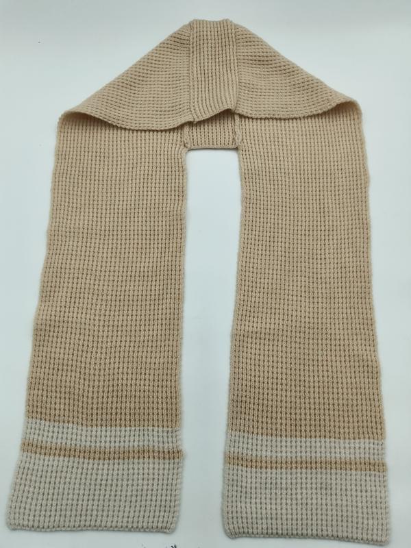 Beige waffle knit scarf with cream contrast stripe cuffs, laid flat on white background showing full length