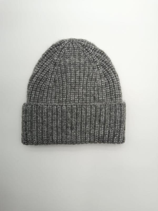 Flat lay of a chunky ribbed knit beanie hat in heather grey with a folded cuff, photographed on white background